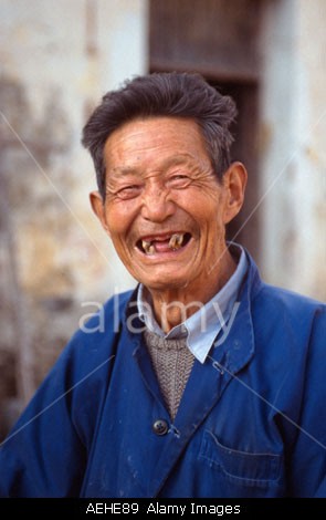 Old man with crooked and missing teeth in the 11th century village of Xidi, Anhui Province China