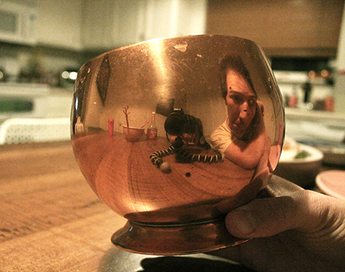 reflections in a copper pot